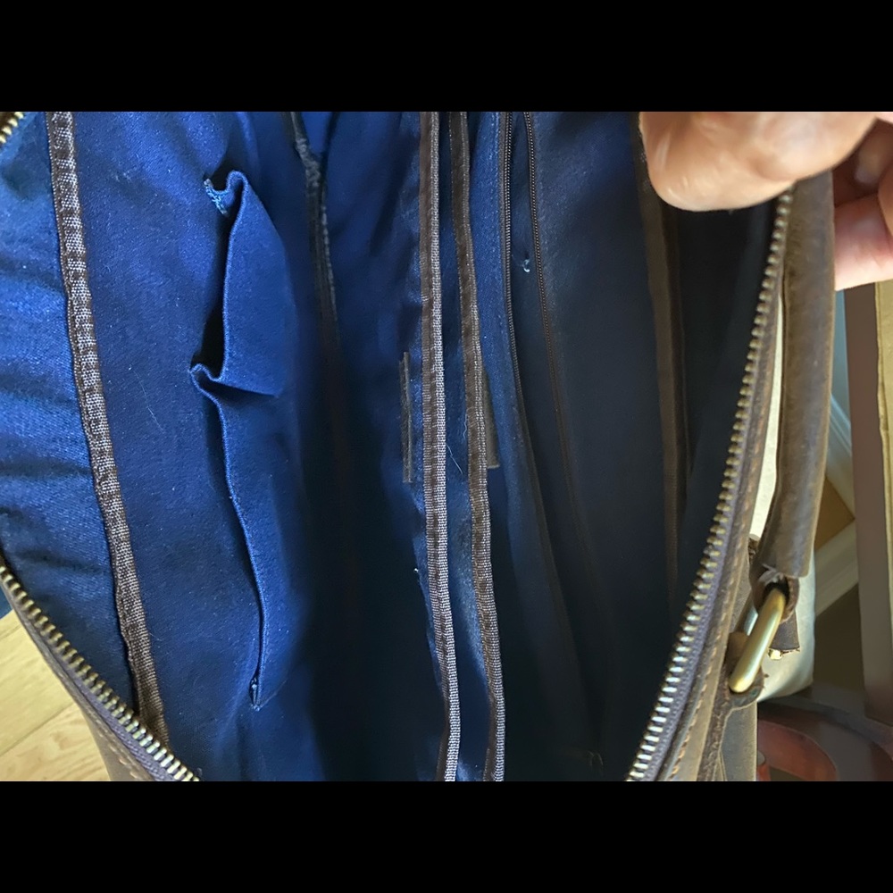 Soft leather briefcase with over-the-shoulder strap. Has dividers for computer.